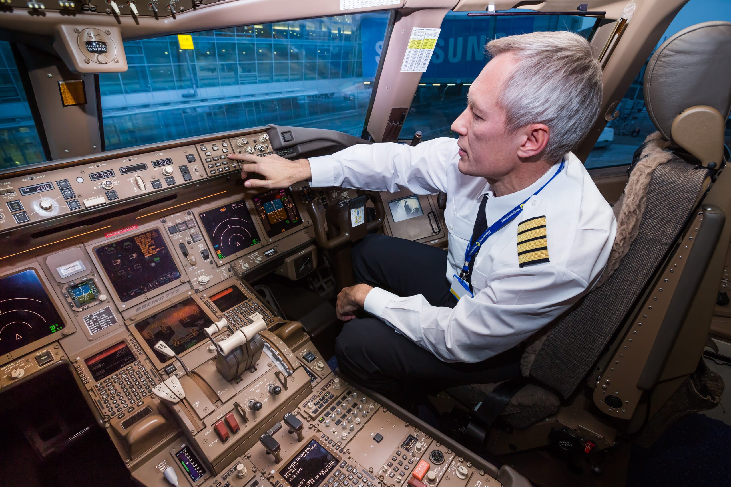 Airline pilot in the cockpit [Credit: Shutterstock]
