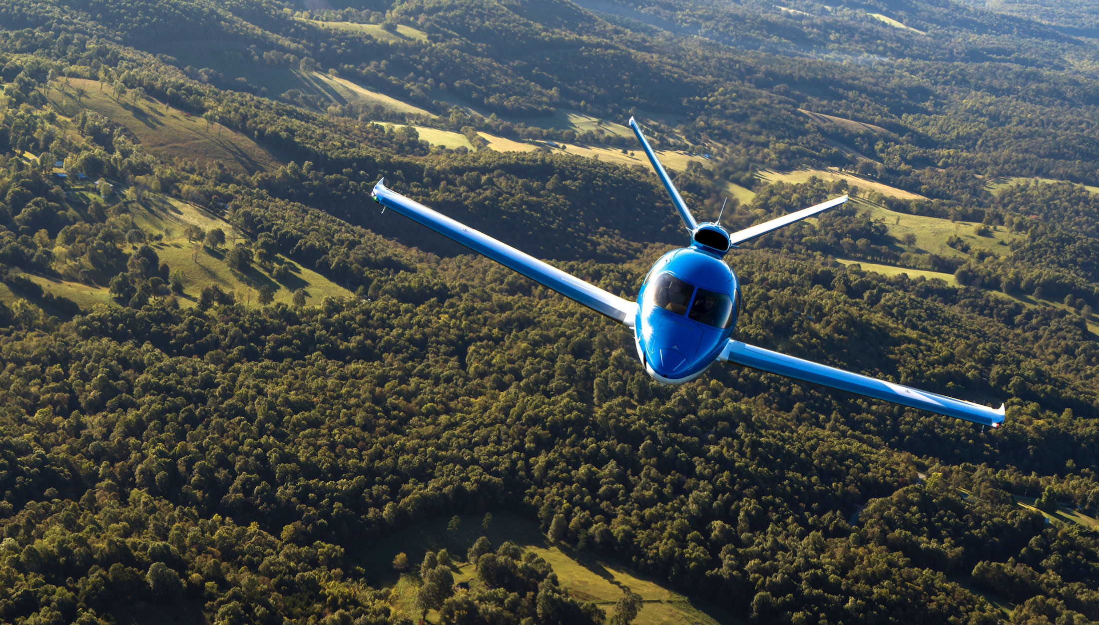 Vision Jet over green hills [Credit: Cirrus]